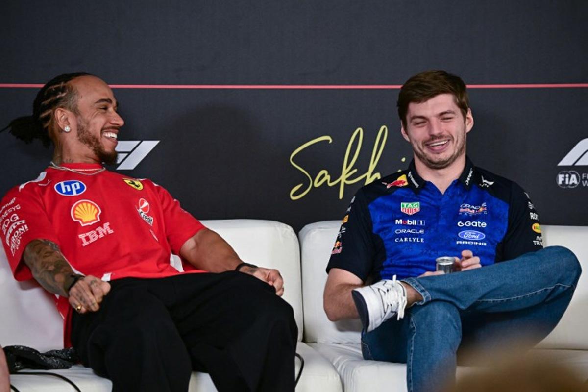 Ferrari's British driver Lewis Hamilton (L) and Red Bull Racing's Dutch driver Max Verstappen attend a press conference on the first day of the second Formula One pre-season test at the Bahrain International Circuit in Sakhir on February 18, 2026. Giuseppe CACACE / AFP
