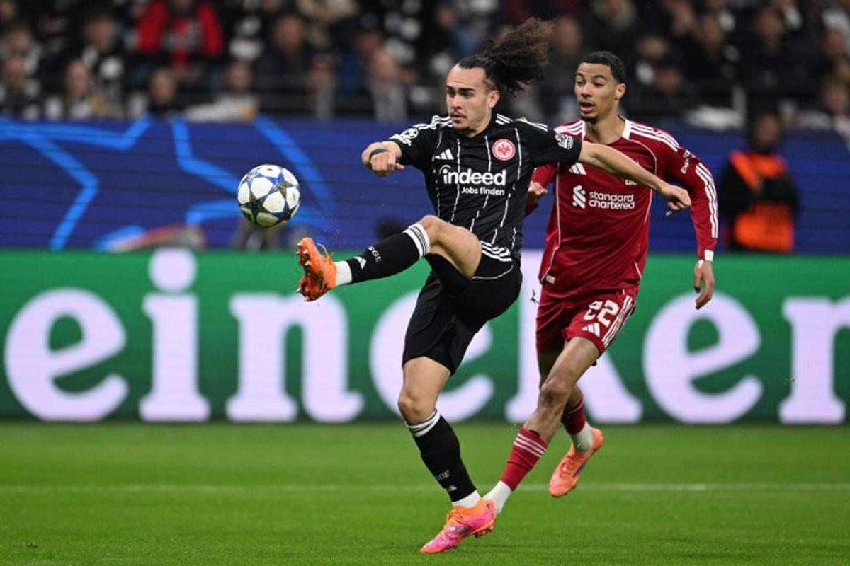 Frankfurt's Belgian defender #03 Arthur Theate (L) and Liverpool's French striker #22 Hugo Ekitike vie for the ball during the UEFA Champions League football match between Eintracht Frankfurt and Liverpool FC in Frankfurt, western Germany on October 22, 2025. Kirill KUDRYAVTSEV / AFP