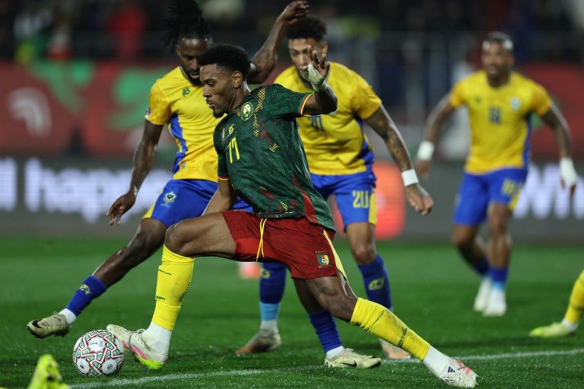 Cameroon's defender #17 Samuel Kotto runs with the ball during the Africa Cup of Nations (CAN) Group F football match between Cameroon and Gabon at Adrar Stadium in Agadir on December 24, 2025. FRANCK FIFE / AFP