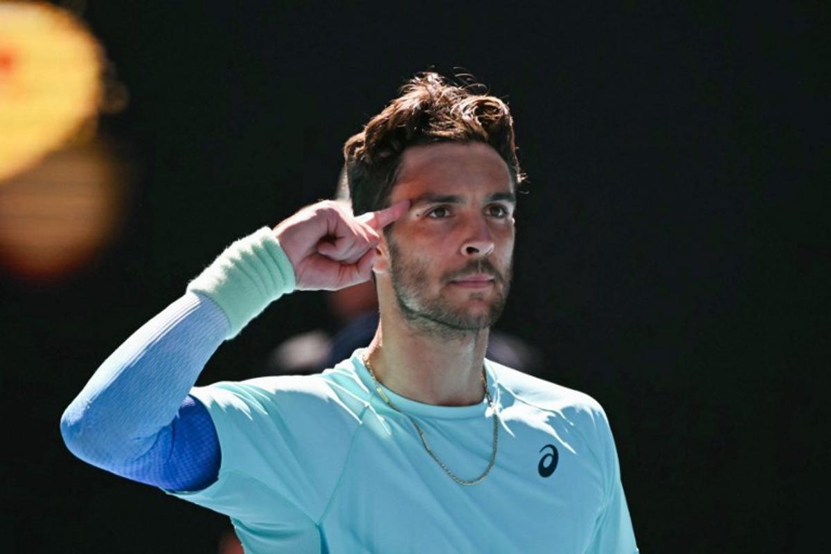 Italy's Lorenzo Musetti celebrates victory against USA's Taylor Fritz in their men's singles match on day nine of the Australian Open tennis tournament in Melbourne on January 26, 2026. WILLIAM WEST / AFP