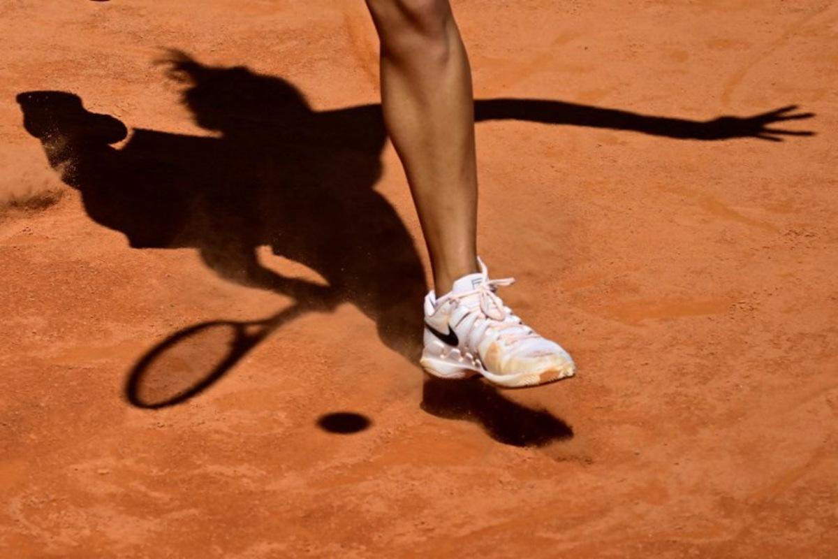 Picture of the shadow of China's Qinwen Zheng during her match against Czech Republic's Linda Noskova at the Women's WTA Rome Open tennis tournament at Foro Italico in Rome on May 11, 2024. Tiziana FABI / AFP