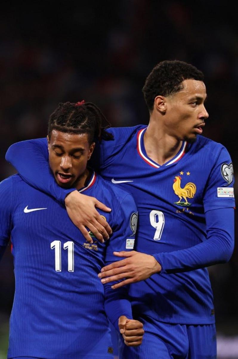France's forward #11 Michael Olise (L) celebrates after scoring his team second goal with France's forward #09 Hugo Ekitike during the 2026 World Cup qualifiers Europe zone group D football match between France and Ukraine at the Parc des Princes stadium in Paris, on November 13, 2025. FRANCK FIFE / AFP