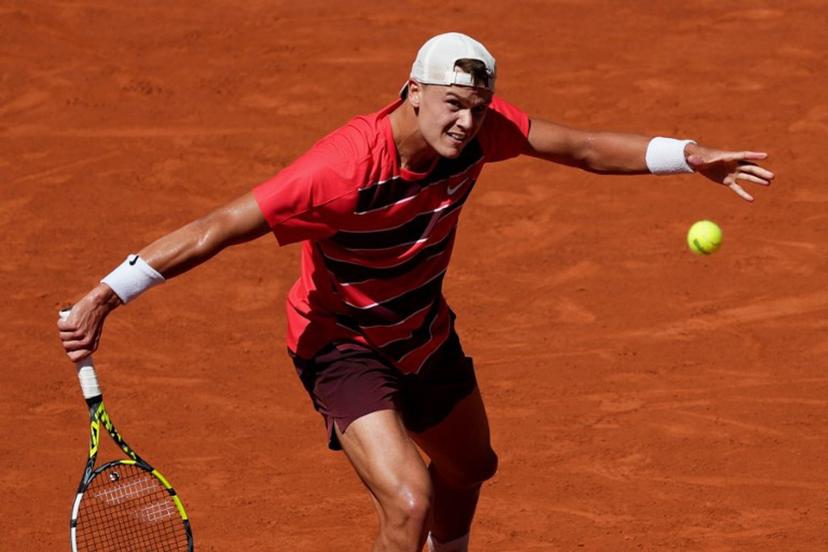 Denmark's Holger Rune plays a backhand return to France's Quentin Halys during their men's singles match on day 6 of the French Open tennis tournament on Court Philippe-Chatrier at the Roland-Garros Complex in Paris on May 30, 2025. Dimitar DILKOFF / AFP