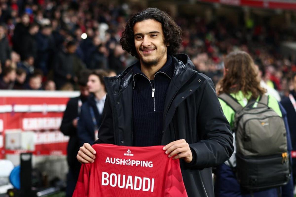 Lille's French midfielder #32 Ayyoub Bouaddi poses for a photograph with a jersey reading "Bouaddi 2029" after his contract's extension with Lille ahead of the French L1 football match between Lille LOSC and Olympique de Marseille (OM) at the Pierre-Mauroy stadium in Villeneuve-d'Ascq, northern France, on December 5, 2025. Sameer Al-Doumy / AFP
