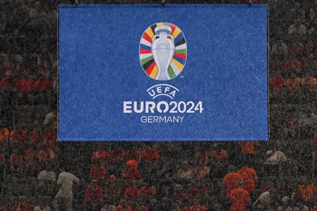 Rain falls in front of the UEFA logo before the start of the UEFA Euro 2024 semi-final football match between the Netherlands and England at the BVB Stadion in Dortmund on July 10, 2024. Kirill KUDRYAVTSEV / AFP