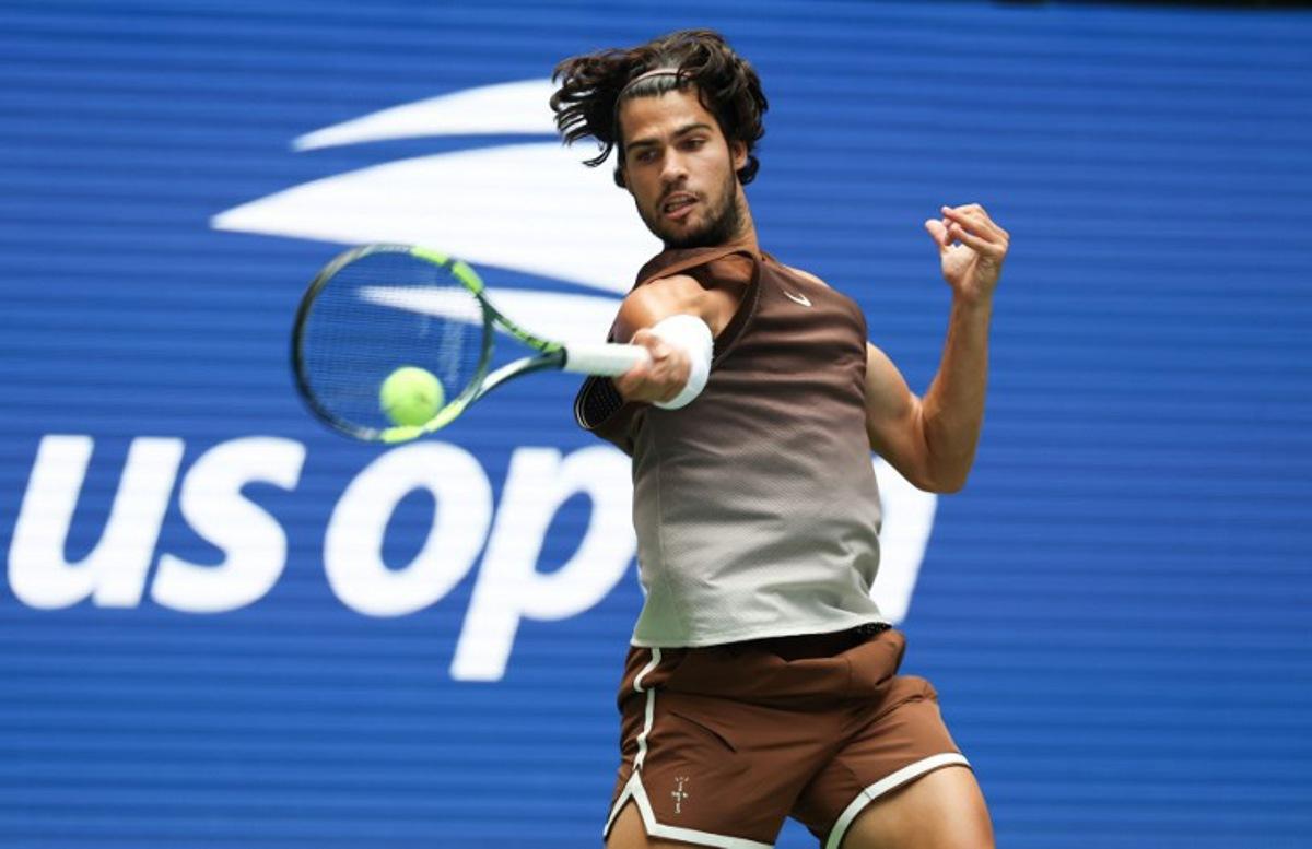 Spain's Carlos Alcaraz hits a return to Russia's Roman Safiullin during their men's singles first round tennis match on day two of the US Open tennis tournament at the USTA Billie Jean King National Tennis Center in New York City on August 31, 2026. TIMOTHY A. CLARY / AFP