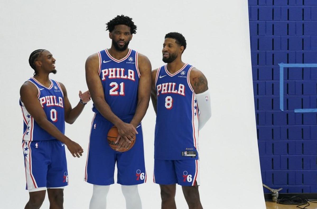 (L-R) Philadelphia 76ers guard Tyrese Maxey, center Joel Embiid and small forward Paul George pose for photos during the 76ers media day ahead of the NBA season at the 76ers Training Complex in Camden, New Jersey, September 30, 2024. TIMOTHY A. CLARY / AFP