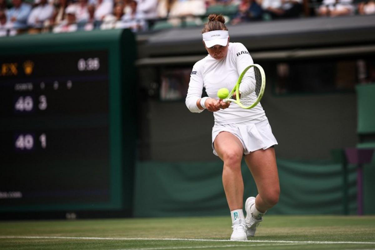 Czech Republic's Barbora Krejcikova plays a backhand return to USA's Emma Navarro during their women's singles third round tennis match on the sixth day of the 2025 Wimbledon Championships at The All England Lawn Tennis and Croquet Club in Wimbledon, southwest London, on July 5, 2025. HENRY NICHOLLS / AFP