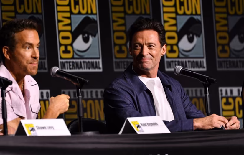 Canadian actor Ryan Reynolds (L) and Australian actor Hugh Jackman speak on stage during "Deadpool and Wolverine" celebration of life fan event during Comic Con International in San Diego, California, July 25, 2024. Chris DELMAS / AFP