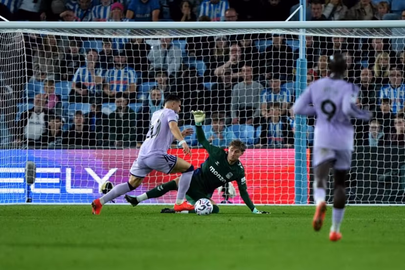 Coventry City's English goalkeeper #19 Carl Rushworth saves a shot from Newcastle United's Belgian striker #20 Matias Fernandez-Pardo during the English Premier League football match between Coventry City and Newcastle United at the Coventry Building Society Arena in Coventry, central England on October 12, 2026. Ben Stansall / AFP