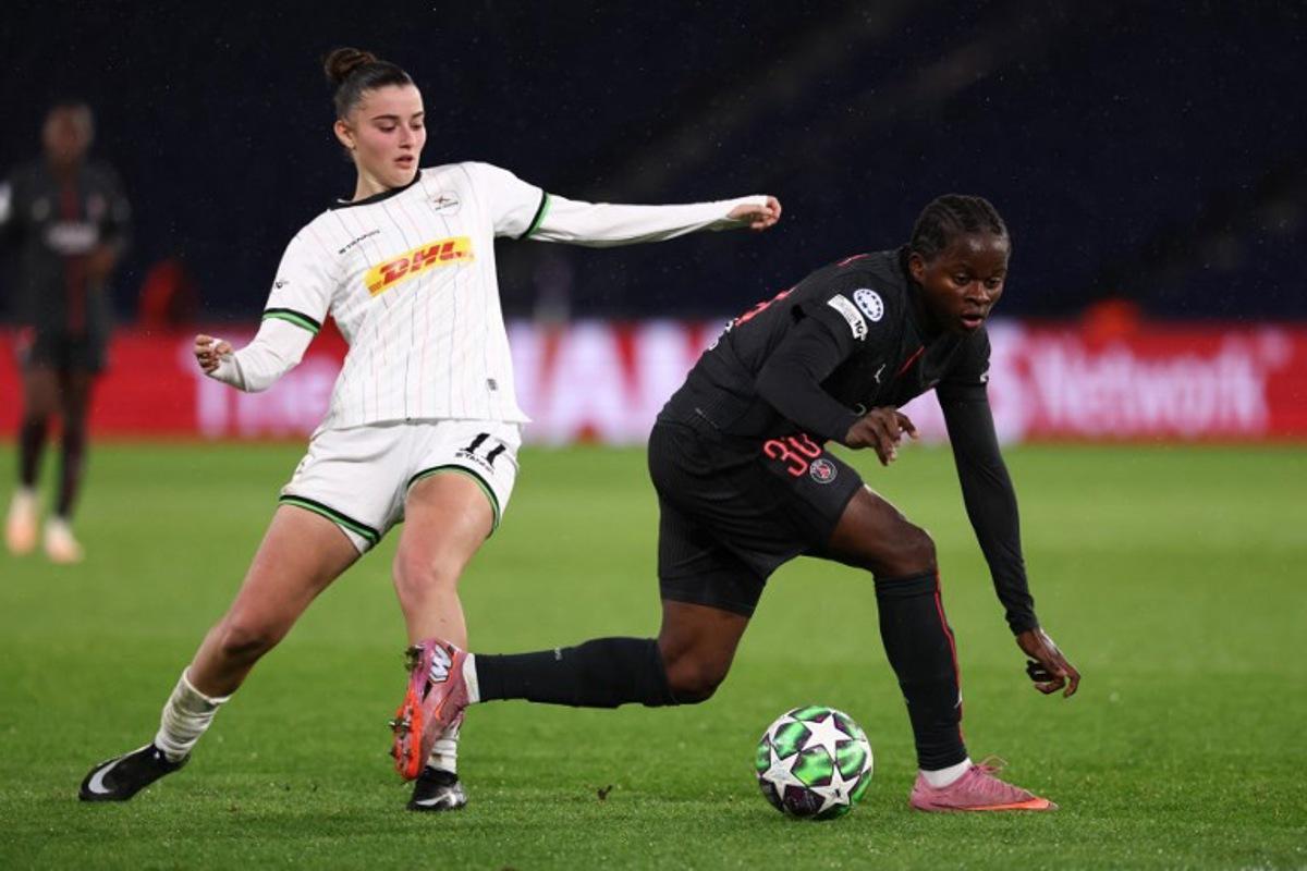 Paris Saint-Germain's Congolese forward #30 Merveille Kanjinga Nanguji (R) fights for the ball with OH Louvain's Greek forward #11 Ioanna Papatheodorou (L) during the UEFA Women's Champions League first round day five football match between Paris Saint-Germain and OH Louvain at the Parc des Princes in Paris on December 9, 2025. FRANCK FIFE / AFP