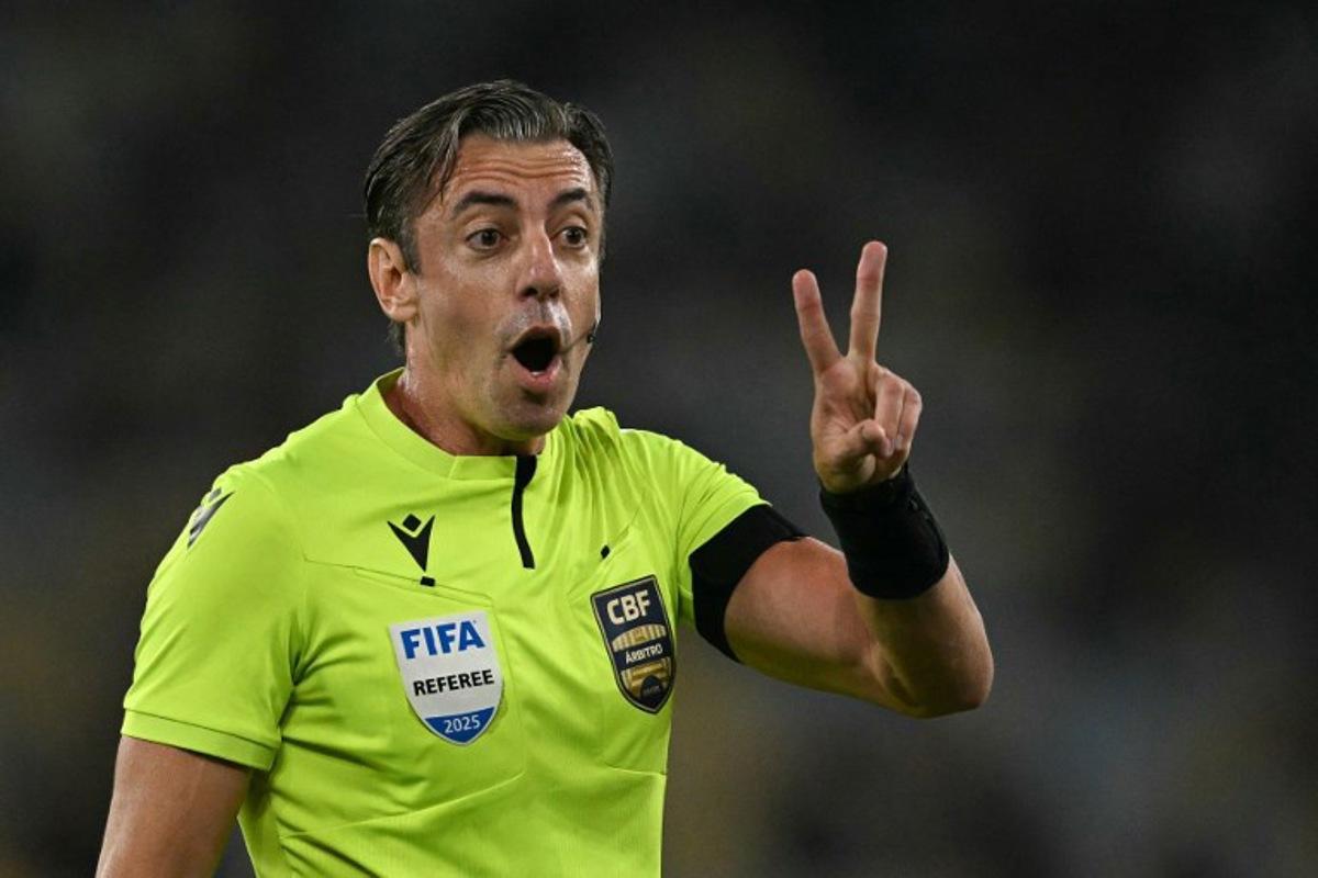 Brazilian referee Raphael Claus gestures during the Brasileirao Serie A football match between Vasco da Gama and Fluminense at the Maracana Stadium in Rio de Janeiro, Brazil, on March 18, 2026. MAURO PIMENTEL / AFP