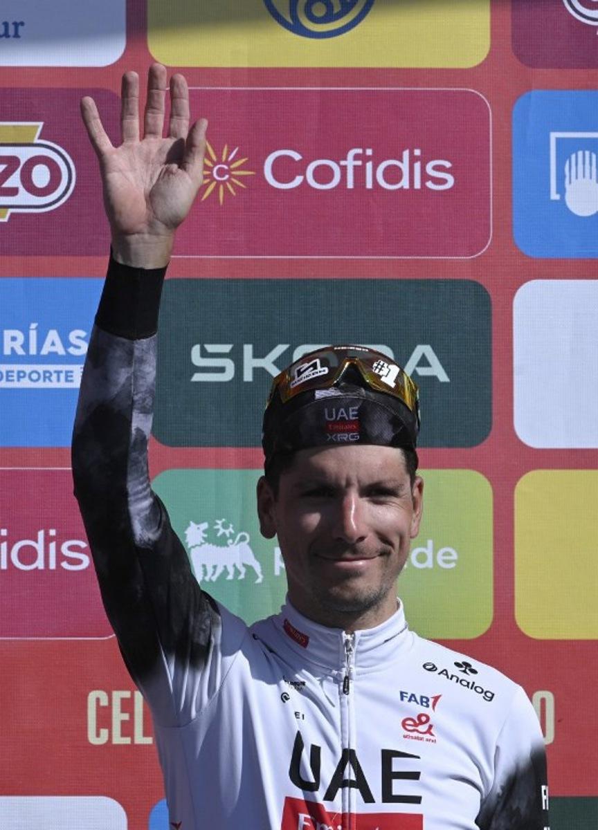 Stage winner, team UAE's Portuguese rider Joao Almeida celebrates on the podium after the 13th stage of the Vuelta a Espana, a 202 km race between Cabezon de la Sal and L'Angliru, on September 5, 2025. Miguel RIOPA / AFP