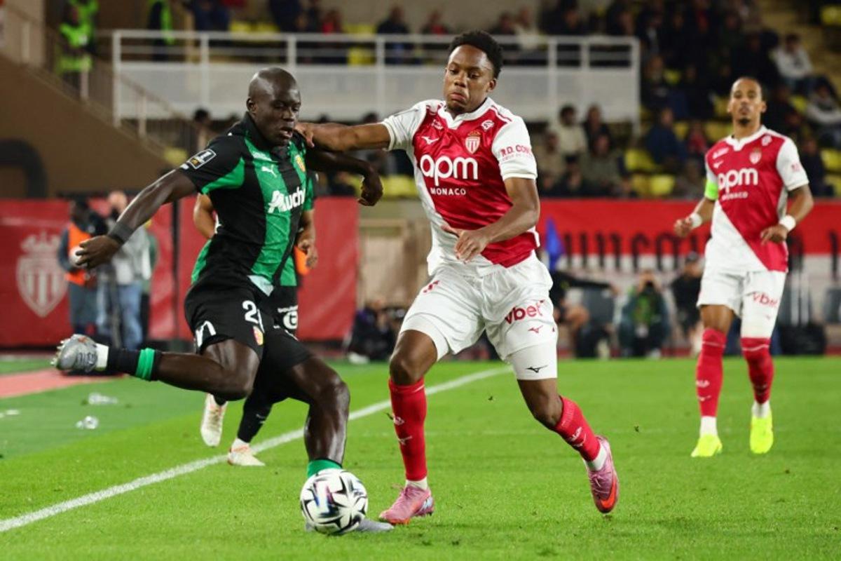 Lens' French defender #20 Malang Sarr (L) fights for the ball with Monaco's French forward #21 Lucas Michal during the French L1 football match between AS Monaco and RC Lens at the Stade Louis II in the Principality of Monaco on November 8, 2025. Clement MAHOUDEAU / AFP