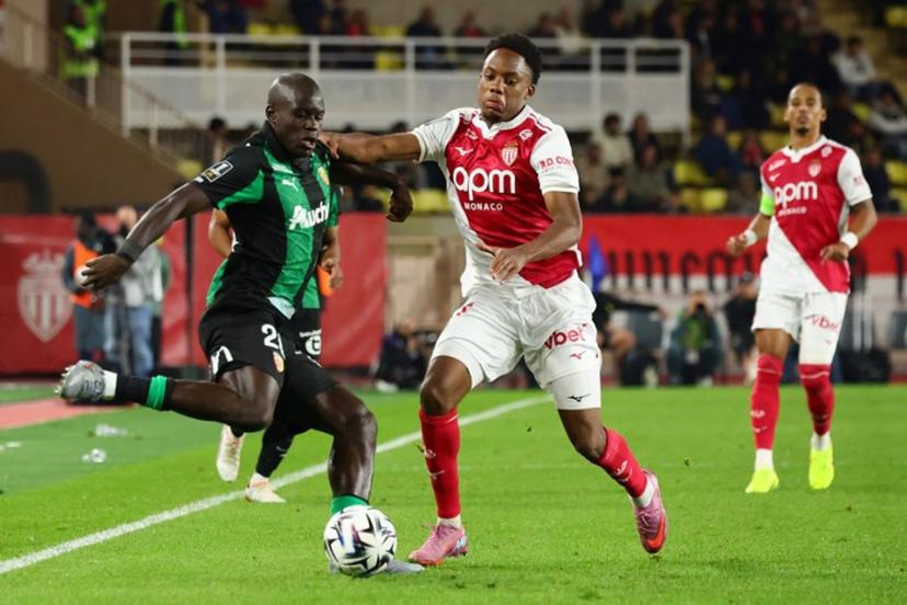 Lens' French defender #20 Malang Sarr (L) fights for the ball with Monaco's French forward #21 Lucas Michal during the French L1 football match between AS Monaco and RC Lens at the Stade Louis II in the Principality of Monaco on November 8, 2025. Clement MAHOUDEAU / AFP