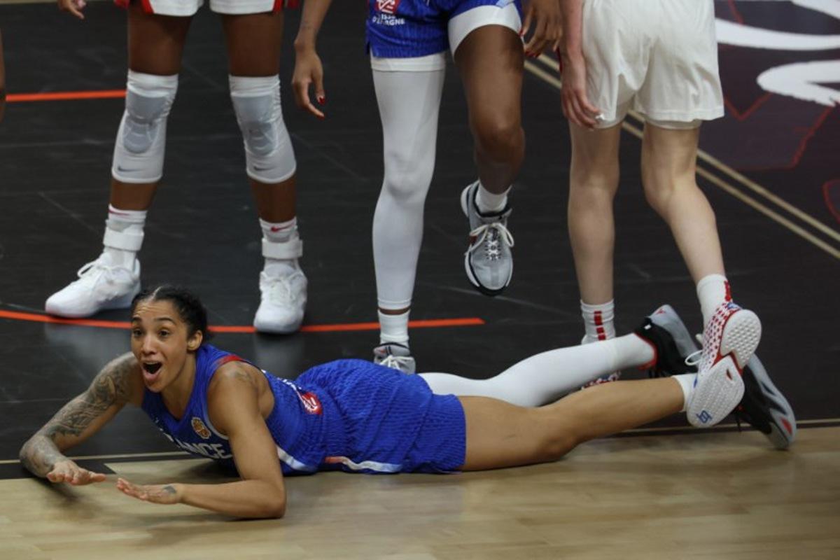 France's forward #15 Gabby Williams reacts as she lays on the pitch during the 2026 FIBA Women's Basketball World Cup final game between the United States and France in Berlin on September 13, 2026. Odd ANDERSEN / AFP