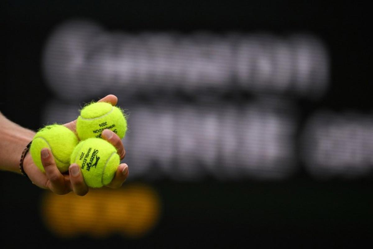 Germany's Alexander Zverev holds tennis balls as he prepares to serve to Britain's Cameron Norrie during their men's singles tennis match on the sixth day of the 2024 Wimbledon Championships at The All England Lawn Tennis and Croquet Club in Wimbledon, southwest London, on July 6, 2024. ANDREJ ISAKOVIC / AFP