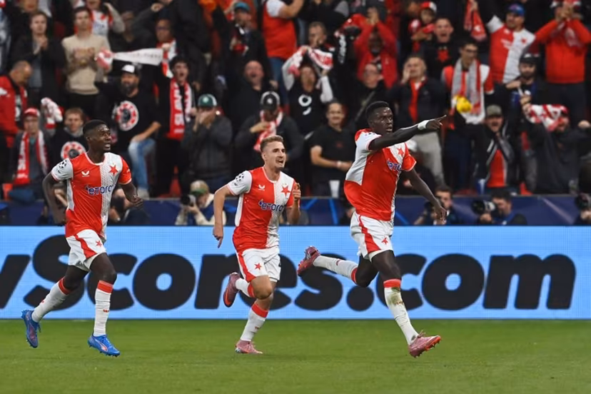 Slavia Prague's Senegalese defender #12 Youssoupha Mbodji (R) celebrates scoring his team's first goal with team mates during the UEFA Champions League football match between SK Slavia Prague and FK Bodoe/Glimt in Prague on September 17, 2025. Michal Cizek / AFP