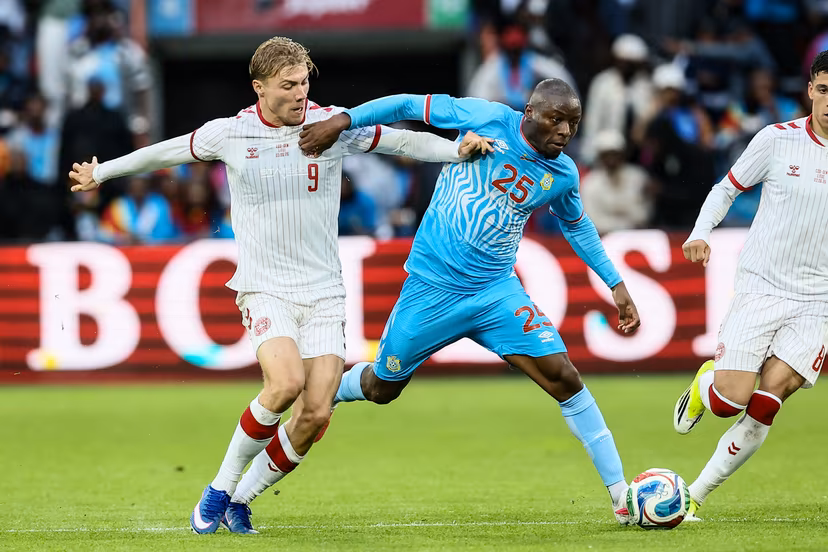 Danish Rasmus Hojlund and Congolese Edo Kayembe fight for the ball during a friendly soccer game between the national teams of DR Congo and Denmark, Wednesday 03 June 2026 in Liege, in preparation of the upcoming the 2026 World Cup. BELGA PHOTO BRUNO FAHY
