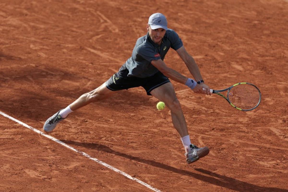 Belgium's Raphael Collignon plays a backhand return to Italy's Matteo Arnaldi during their men's singles match on day 7 of the French Open tennis tournament at the Roland-Garros Complex in Paris on May 30, 2026. Thomas SAMSON / AFP