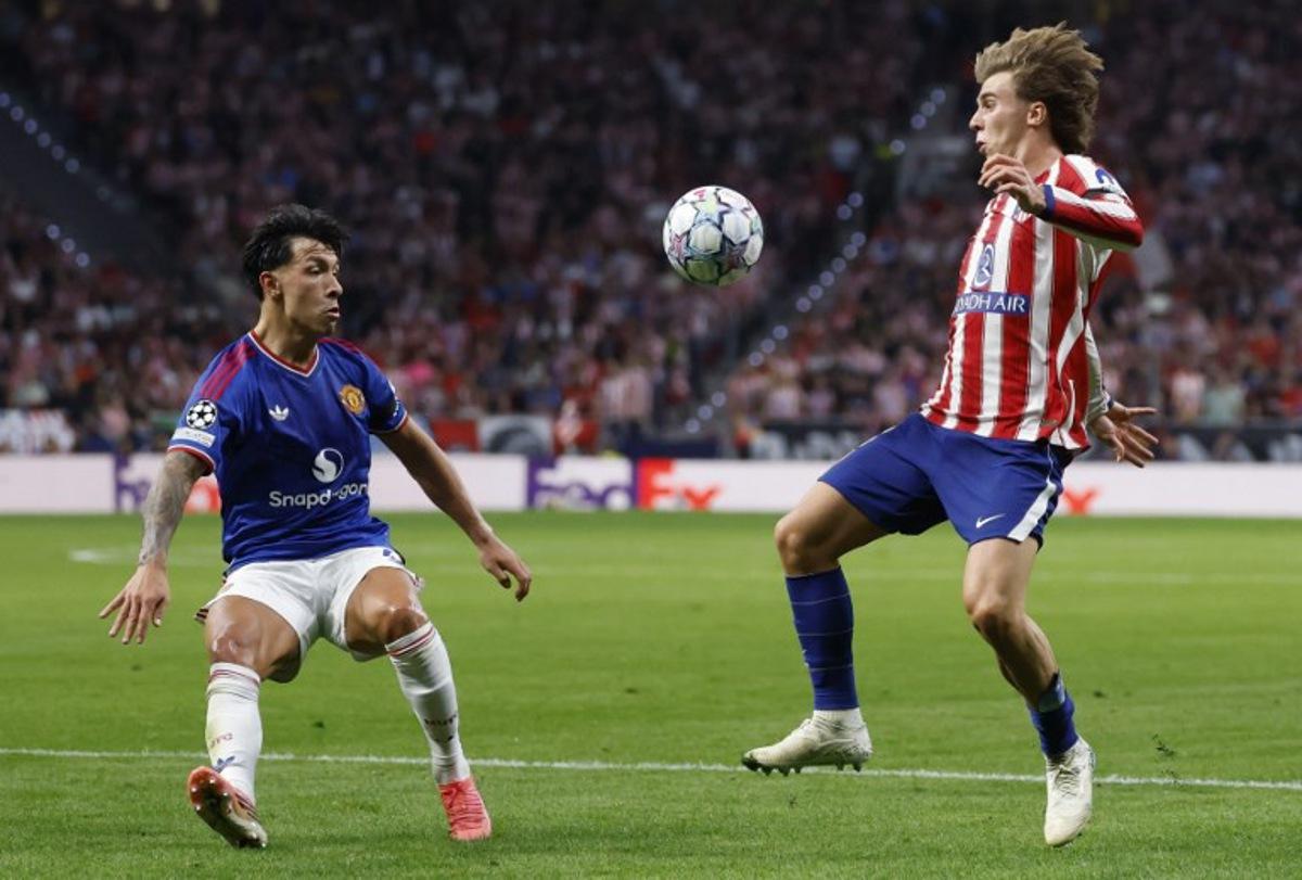 Manchester United's Argentinian defender #06 Lisandro Martinez fights for the ball with Atletico Madrid's Spanish midfielder #08 Pablo Barrios during the UEFA Champions League, league phase, matchday 2, football match between Club Atletico de Madrid and Manchester United at the Metropolitano stadium in Madrid on October 13, 2026. Oscar DEL POZO / AFP