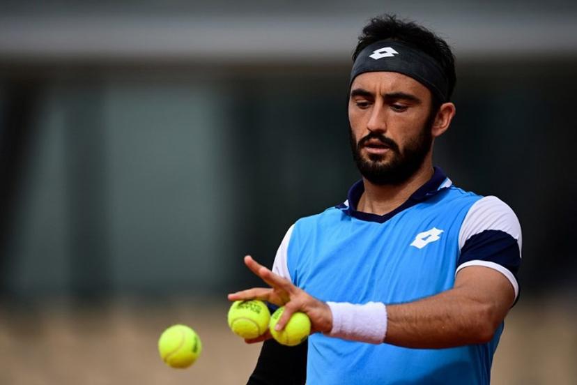 Italy's Lorenzo Giustino reacts as he plays against Argentina's Diego Schwartzman during their men's singles second round tennis match on Day 4 of The Roland Garros 2020 French Open tennis tournament in Paris on September 30, 2020. MARTIN BUREAU / AFP