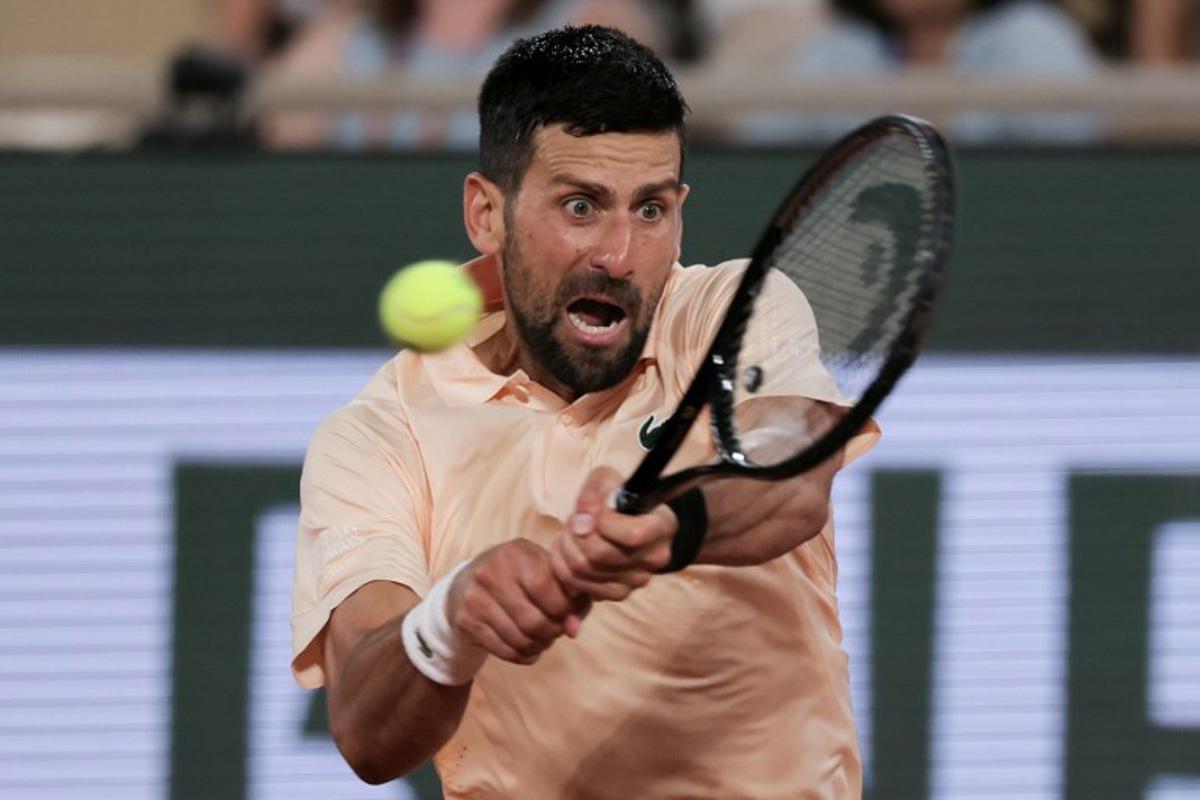 Serbia's Novak Djokovic plays a backhand return to France's Giovanni Mpetshi Perricard during their men's singles match on day 1 of the French Open tennis tournament on Court Philippe-Chatrier at the Roland-Garros Complex in Paris on May 24, 2026. Thomas SAMSON / AFP
