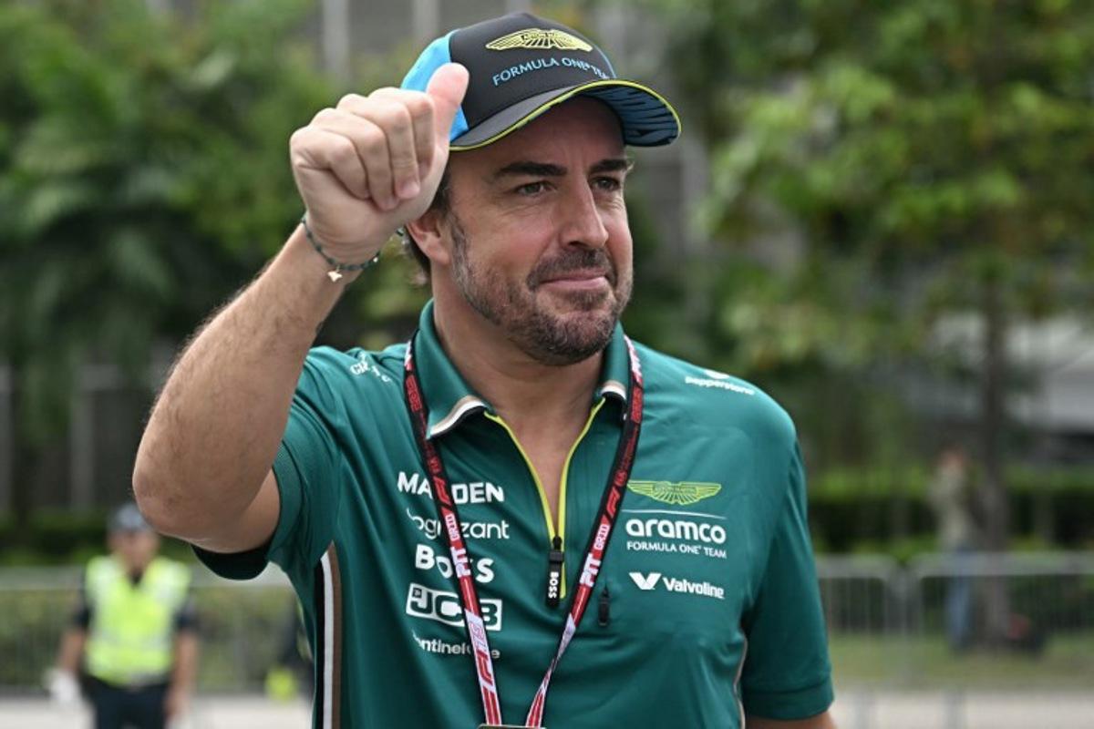 Aston Martin's Spanish driver Fernando Alonso gestures to fans before the first practice session ahead of the Formula One Singapore Grand Prix night race at the Marina Bay Street Circuit in Singapore on October 3, 2025. Lillian SUWANRUMPHA / AFP