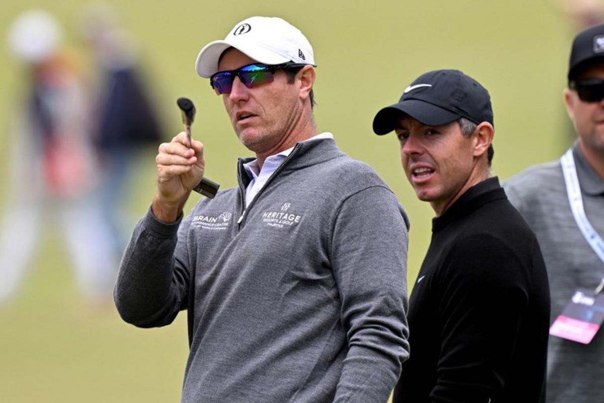 Nicolas Colsaerts of Belgium (L) chats with Northern Ireland's Rory McIlroy (R) during a practice round ahead of the Australian Open golf tournament at the Royal Melbourne Golf Club in Melbourne on December 2, 2025. William WEST / AFP
