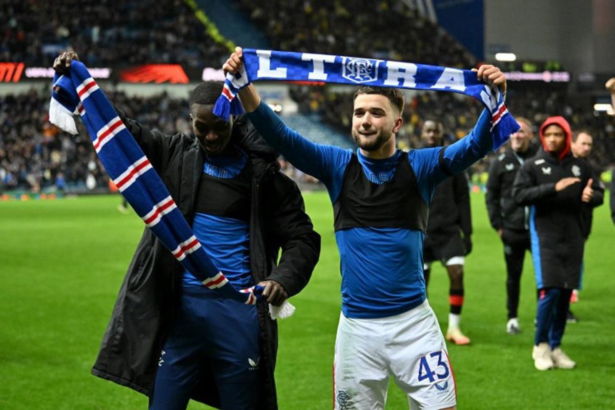 Rangers' Belgian midfielder #43 Nicolas Raskin and Rangers' Ivorian midfielder #10 Mohammed Diomande (L) celebrate following the UEFA Europa League second-leg round of 16 football match between Rangers and Fenerbahce SK at the Ibrox Stadium in Glasgow on March 13, 2025. ANDY BUCHANAN / AFP