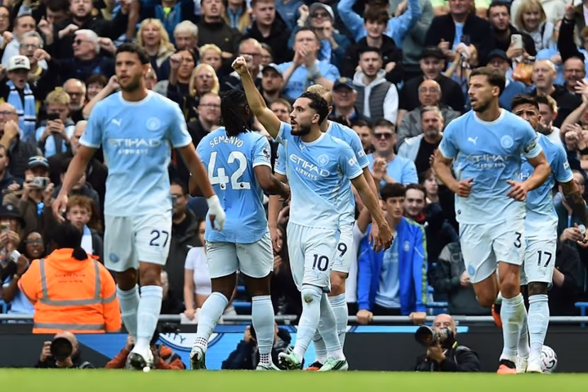 Manchester City's French midfielder #10 Rayan Cherki (C) celebrates with teammates after scoring their second goal during the English Premier League football match between Manchester City and Sunderland at the Etihad Stadium in Manchester, north west England, on September 20, 2026. PETER POWELL / AFP