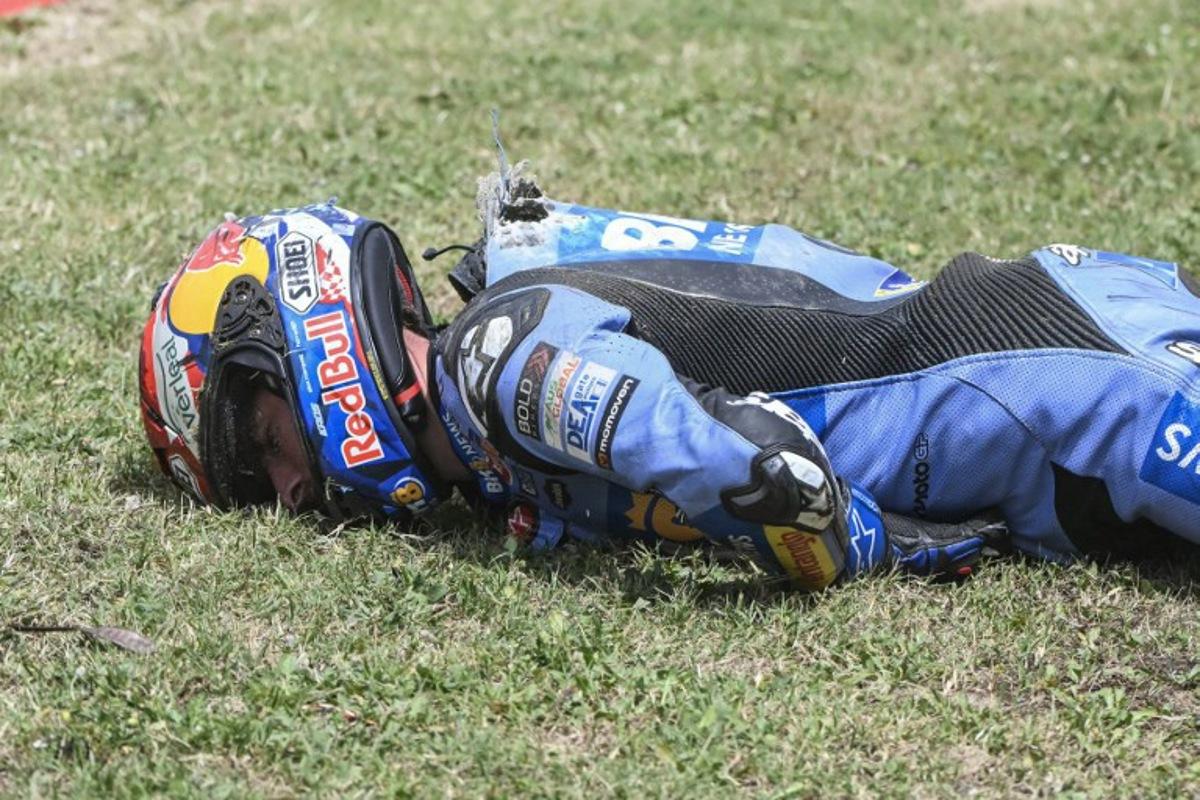 Team Gresini Racing MotoGP's Alex Marquez lies on the side of the track after crashing at high speed during the 2026 Catalunya Moto GP Grand Prix at the Catalunya racetrack in Montmelo, near Barcelona, on May 17, 2026. JOSE JORDAN / AFP