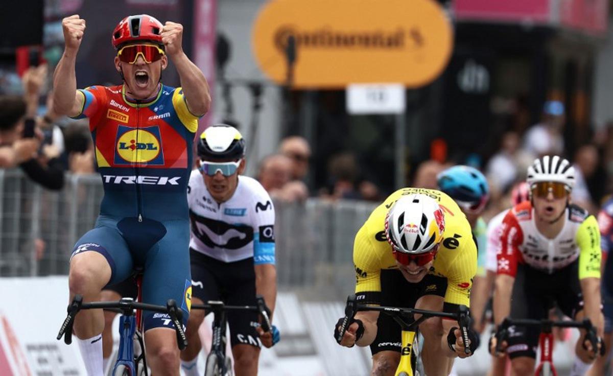 Lidl-Trek's Danish rider Mads Pedersen, next to Team Visma-Lease a Bike's Belgian rider Wout Van Aert (R), celebrates as he crosses the finish to win the first stage of the 108th Giro d'Italia cycling race, 160km from Durres to Tirana in Albania, on May 9, 2025. Luca Bettini / AFP