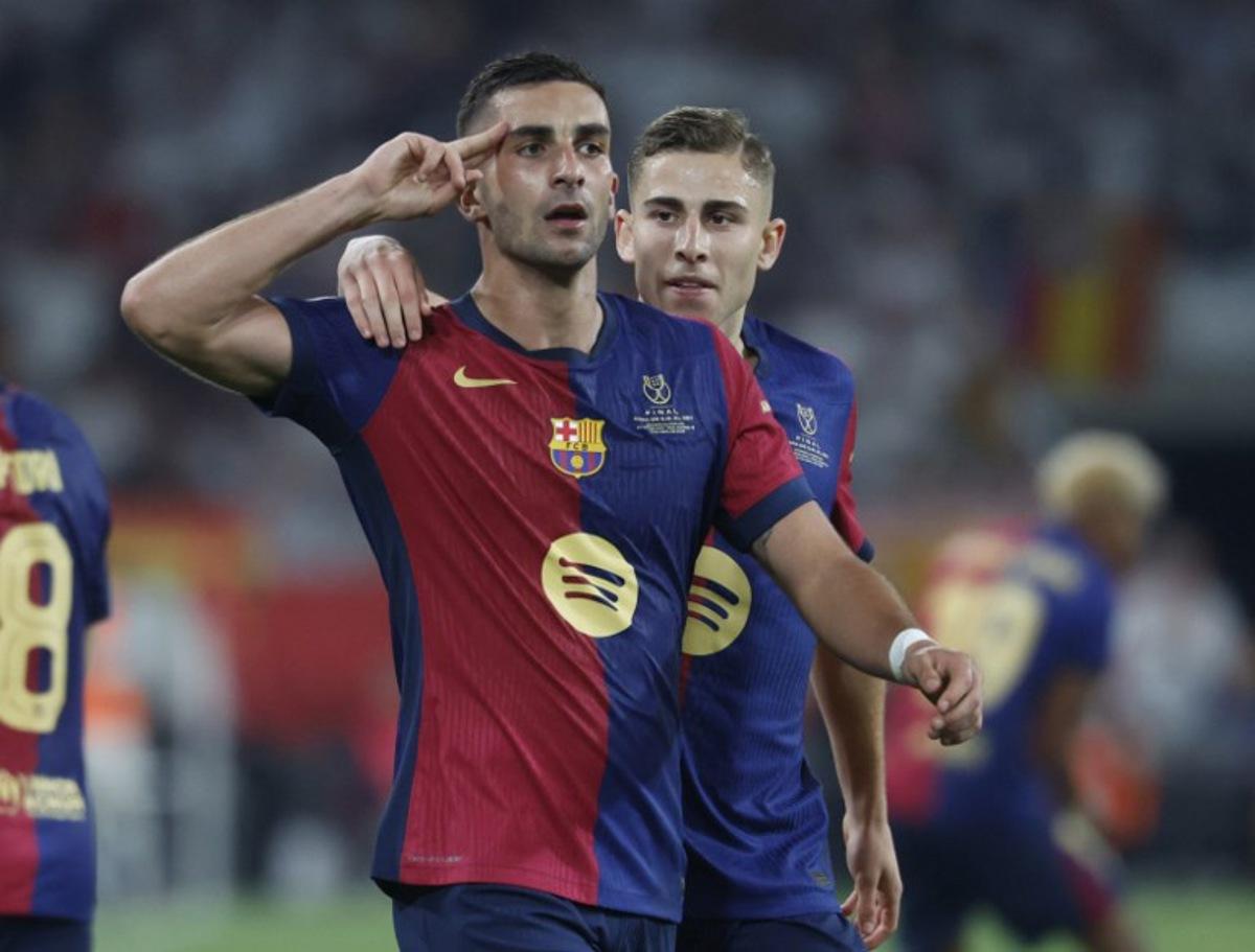 Barcelona's Spanish forward #07 Ferran Torres celebrates with Barcelona's Spanish midfielder #16 Fermin Lopez (R) after scoring his team's second goal during their Spanish Cup, Copa del Rey (King's Cup) final football match between FC Barcelona and Real Madrid CF at La Cartuja stadium in Seville on April 26, 2025. Pierre-Philippe MARCOU / AFP