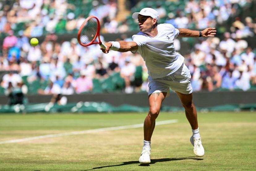 Italy's Flavio Cobolli returns to Australia's Alex De Minaur during their men's singles round of 16 tennis match on the eighth day of the 2026 Wimbledon Championships at The All England Lawn Tennis and Croquet Club in Wimbledon, southwest London, on July 6, 2026. Kirill KUDRYAVTSEV / AFP