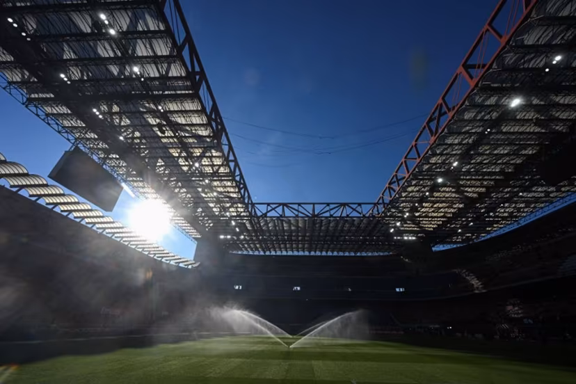 Sprinklers spray water on the pitch ahead of the Italian Serie A football match between AC Milan and Sassuolo at the San Siro Stadium in Milan, Italy on December 14, 2025. Piero CRUCIATTI / AFP
