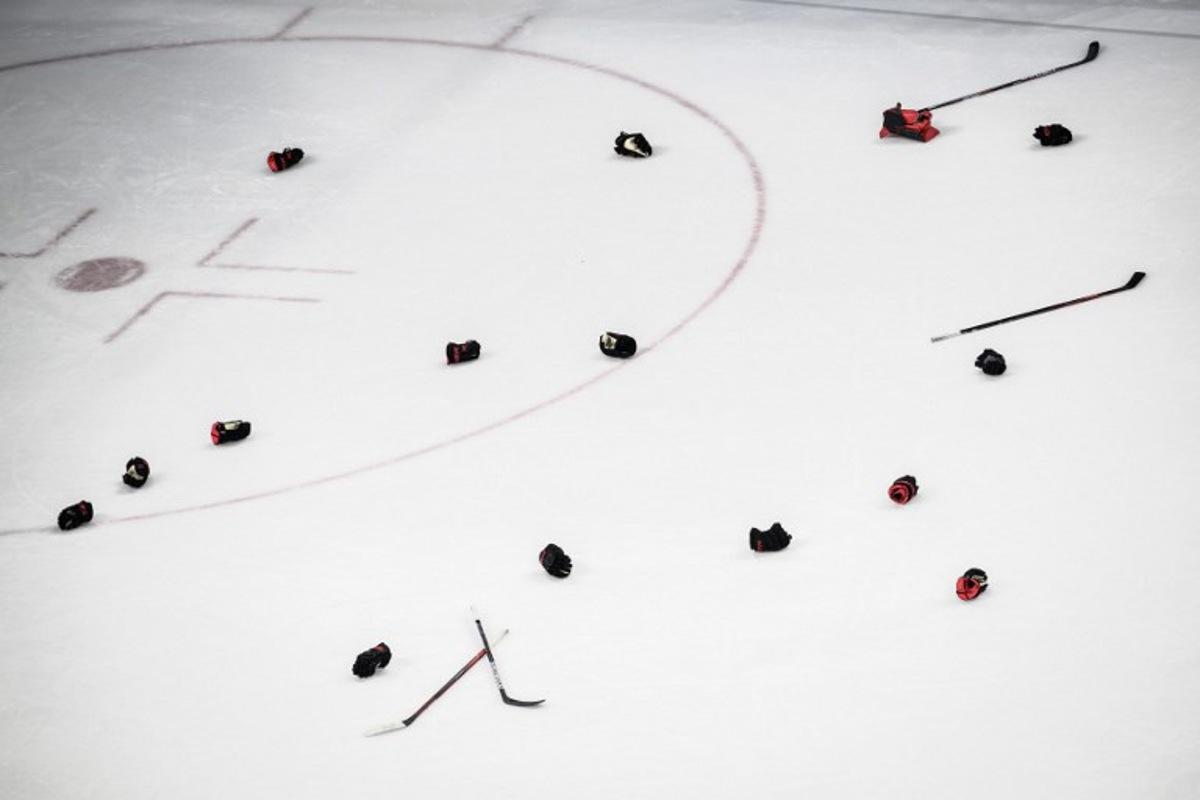 Canadian players' gloves and sticks are seen after their victory during the women's gold medal match of the Beijing 2022 Winter Olympic Games ice hockey competition between Canada and USA, at the Wukesong Sports Centre in Beijing on February 17, 2022. Jeff PACHOUD / AFP