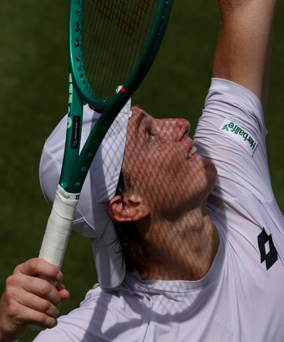 Peru's Ignacio Buse serves to US player Jenson Brooksby during their men's singles second round tennis match on the third day of the 2026 Wimbledon Championships at The All England Lawn Tennis and Croquet Club in Wimbledon, southwest London, on July 1, 2026. Adrian Dennis / AFP