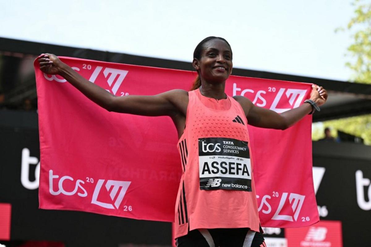 Ethiopia's Tigst Assefa poses after crossing the line to win the women's race in a new women's only world record at the 2026 London Marathon in central London on April 26, 2026. JUSTIN TALLIS / AFP