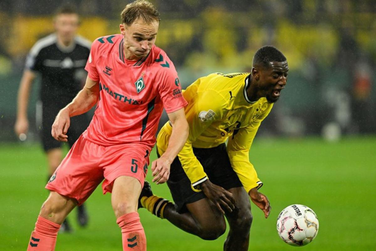 Bremen's German defender #05 Amos Pieper (L) and Dortmund's Guinean forward #09 Serhou Guirassy vie for the ball during the German Cup (DFB-Pokal) football match between BVB Borussia Dortmund and Werder Bremen in Dortmund, western Germany on October 27, 2026. INA FASSBENDER / AFP