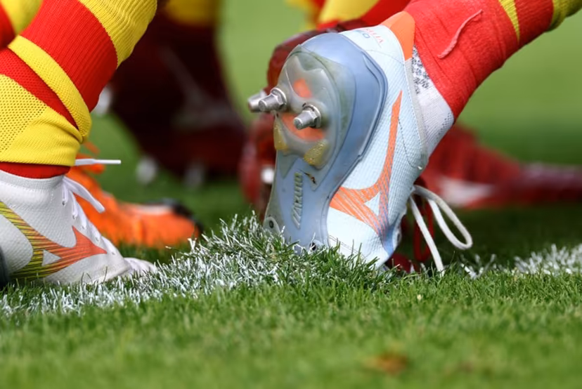 This photograph shows shoe studs on the pitch as Perpignan's players warm up ahead of the French Top14 rugby union match between Racing 92 and Perpignan (USAP) at Stade Dominique-Duvauchelle in Creteil, on the outskirts of Paris, on October 3, 2026. FRANCK FIFE / AFP
