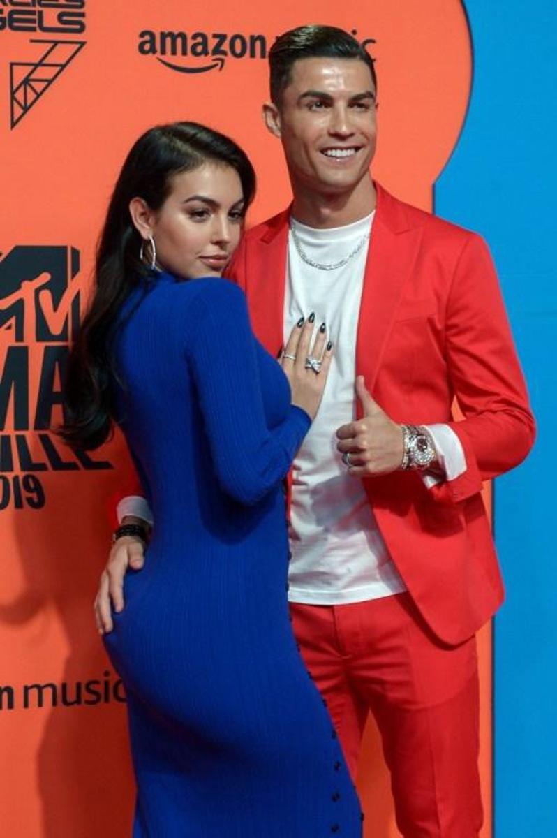 Juventus' Portuguese forward Cristiano Ronaldo (R) and his wife Georgina Rodriguez pose on the red carpet upon their arrival to the MTV Europe Music Awards at the FIBES Conference and Exhibition Centre of Seville on November 3, 2019. CRISTINA QUICLER / AFP
