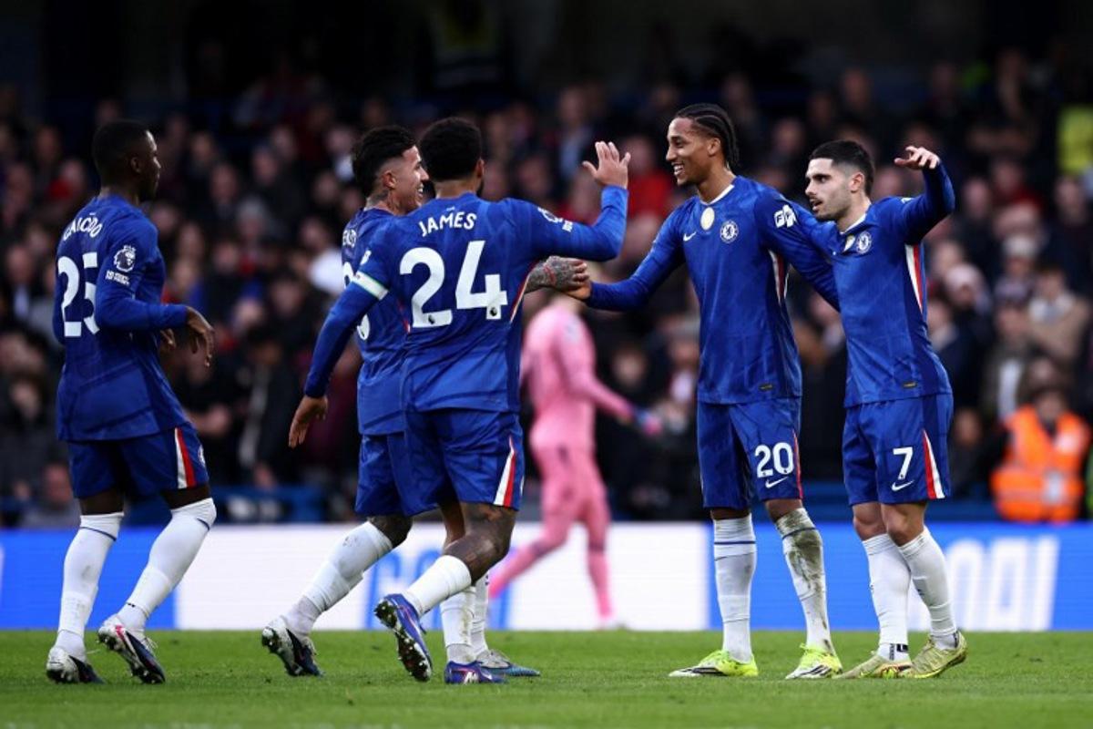 Chelsea's Brazilian striker #20 Joao Pedro (2R) celebrates scoring the team's first goal alongside Chelsea's Portuguese midfielder #07 Pedro Neto (R) during the English Premier League football match between Chelsea and Brentford at Stamford Bridge in London on January 17, 2026. Henry NICHOLLS / AFP