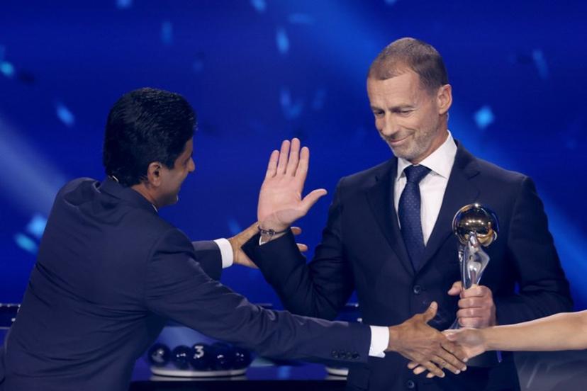 Paris Saint Germain's Qatari president Nasser al-Khelaifi (L) receives UEFA Respect Award from UEFA President Aleksander Ceferin during the draw ceremony for the league phase of the 2026-2027 UEFA Champions League football tournament at the Grimaldi Forum in the Principality of Monaco on August 27, 2026. Valery HACHE / AFP