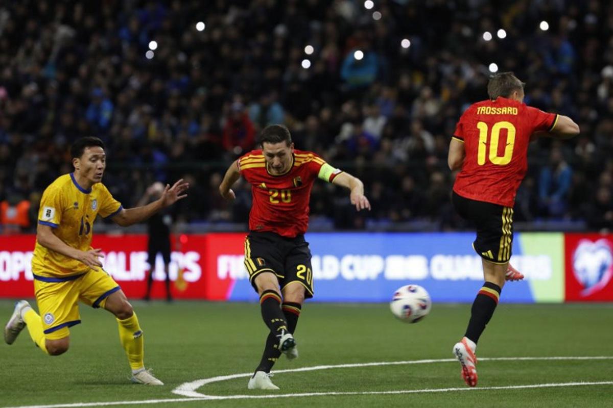 Kazakhstan's defender Erkin Tapalov, Belgium's midfielder #20 Hans Vanaken and Belgium's midfielder #10 Leandro Trossard vie for the ball during the FIFA World Cup 2026 qualifiers Europe zone group J football match between Kazakhstan and Belgium at the Astana Arena in Astana on November 15, 2025. STANISLAV FILIPPOV / AFP