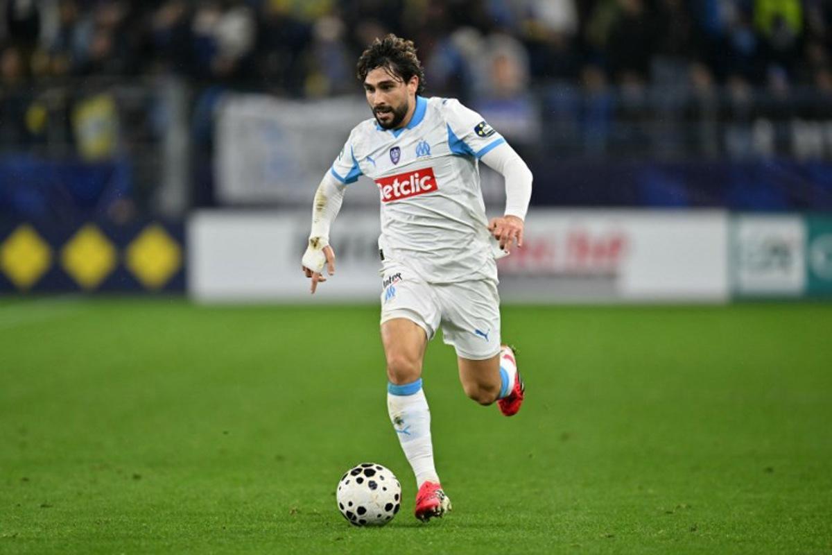 Marseille's French forward #15 Neal Maupay runs with the ball during the French Cup round of 32 football match between FC Bayeux and Olympique de Marseille (OM) at the Michel-d'Ornano Stadium in Caen on January 13, 2026. LOU BENOIST / AFP