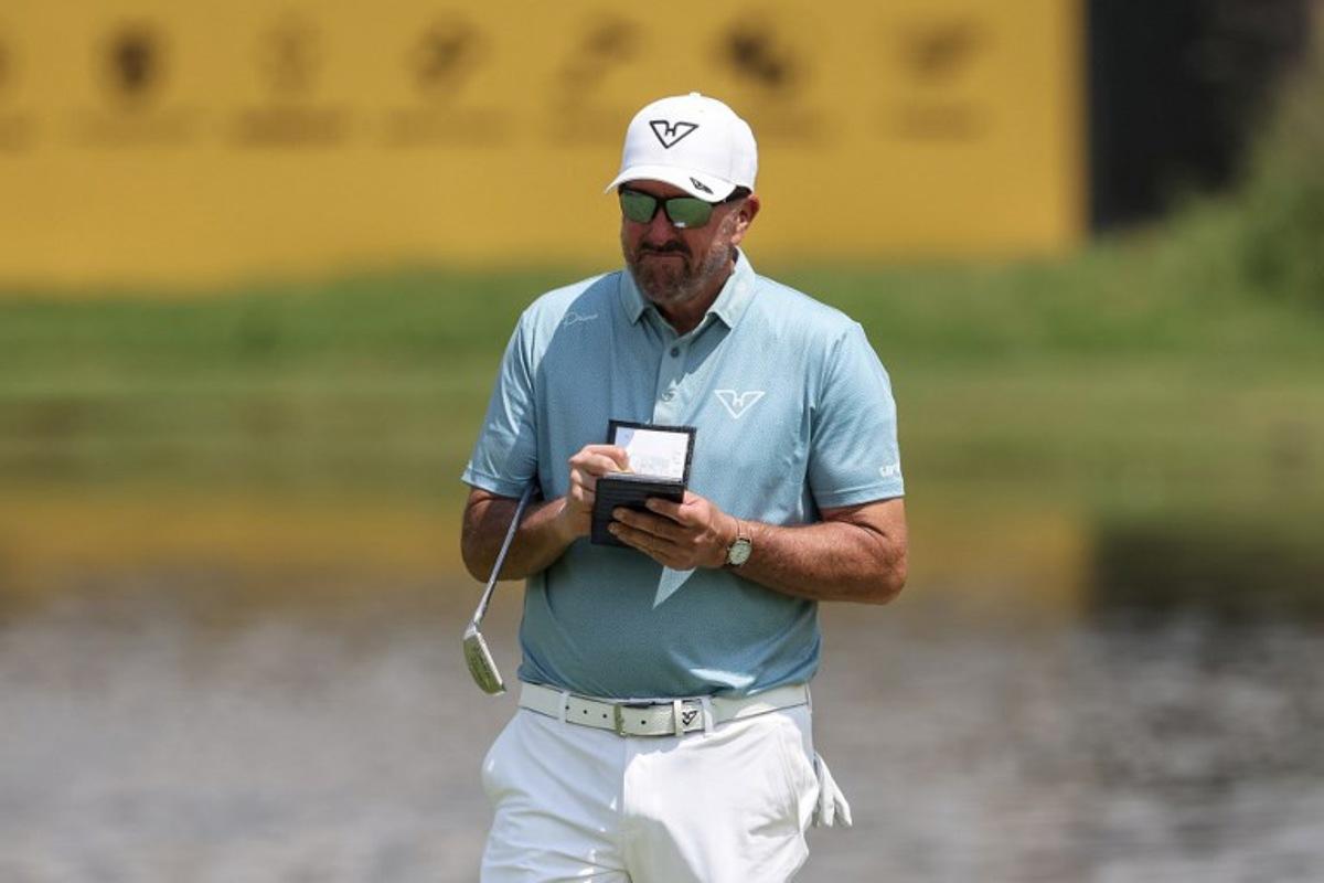Hyflyers GC's US player Phil Mickelson reacts after putting on the 12th green on the first day of the LIV Golf South Africa tournament at The Club in Steyn City on March 19, 2026. PHILL MAGAKOE / AFP
