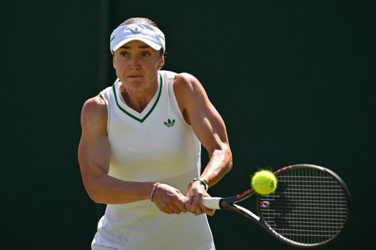 Ukraine's Elina Svitolina plays a backhand return to Hungary's Anna Bondar during their women's singles first round tennis match on the first day of the 2025 Wimbledon Championships at The All England Lawn Tennis and Croquet Club in Wimbledon, southwest London, on June 30, 2025. Glyn KIRK / AFP