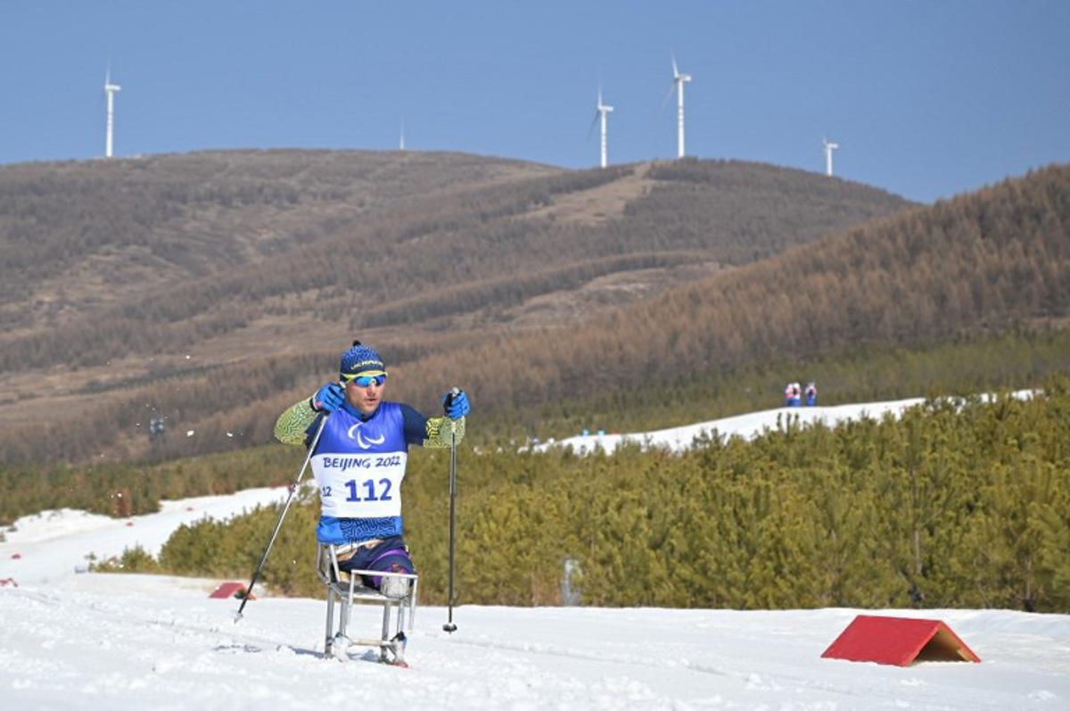 Ukraine's Pavlo Bal competes in the men's middle distance sitting para cross-country skiing final event on March 12, 2022, at the Zhangjiakou National Biathlon Centre during the Beijing 2022 Winter Paralympic Games. Mohd RASFAN / AFP