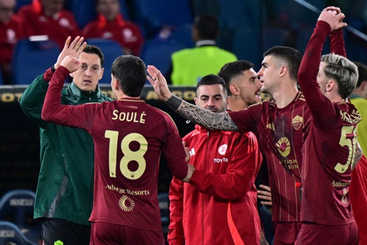 Roma's Argentine forward #18 Matias Soule celebrates scoring his team's first goal during the Italian Serie A football match between Lazio and Roma at the Olympic Stadium in Rome on April 13, 2025. Tiziana FABI / AFP